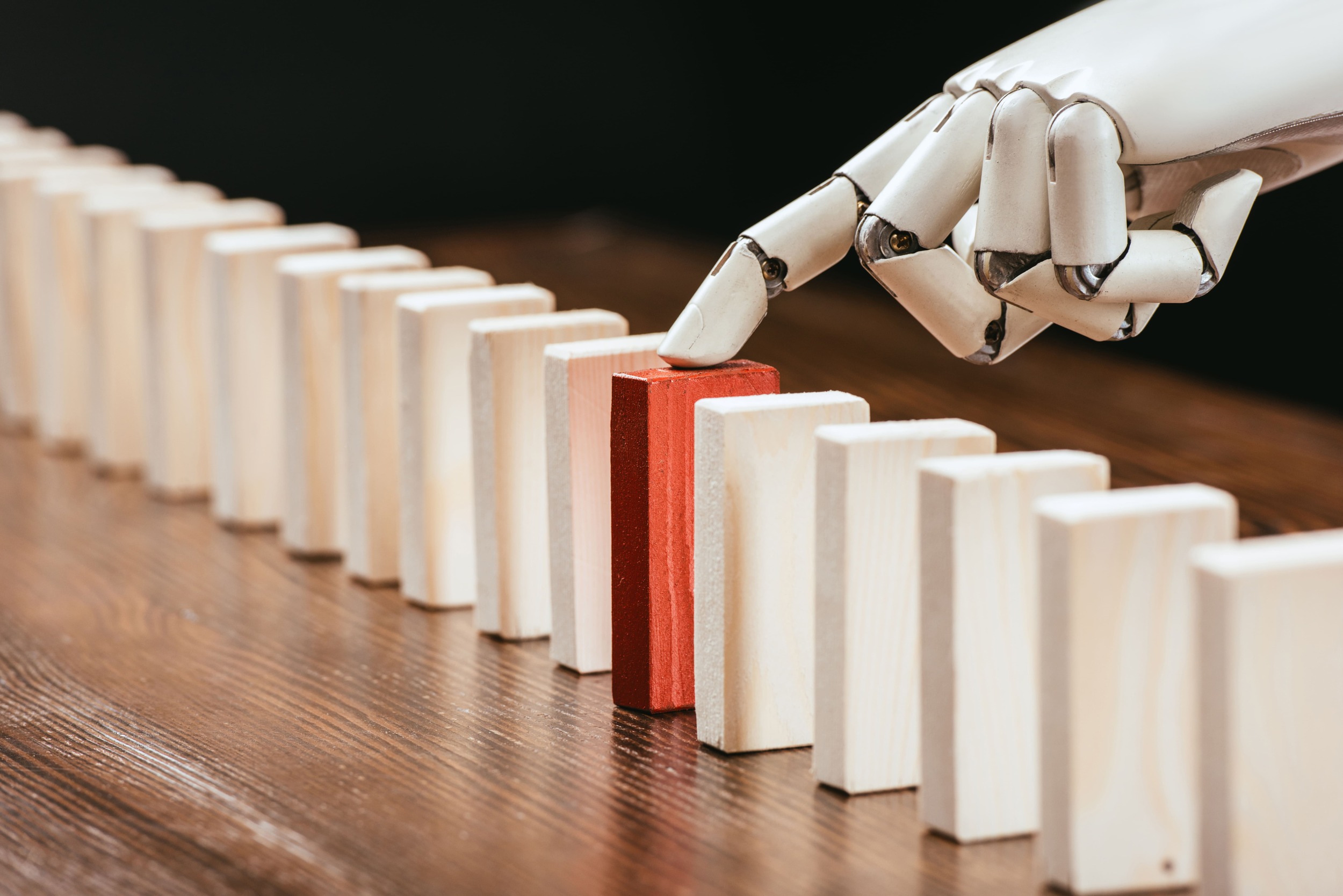 selective-focus-of-robotic-hand-picking-red-wooden